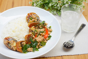Rice topped with stir-fried preserved egg slice and basil.
