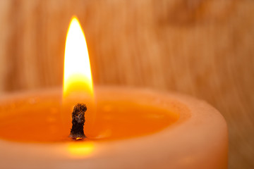 Burning candle closeup on light background. - obrazy, fototapety, plakaty