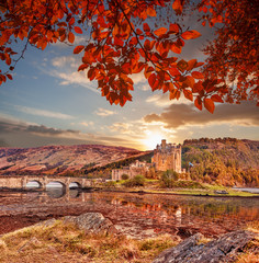 Eilean Donan Castle against autumn leaves in Highlands of Scotland