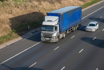 Road transport. Articulated lorry in motion on the motorway