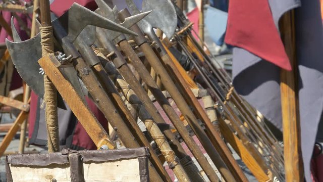 Medieval axes and other weapons standing.