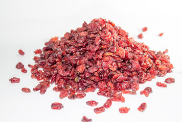 An isolated pile of sun dried red barberry on white background 