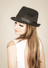 Pretty young woman with a hat isolated on a white background: fashion photography
