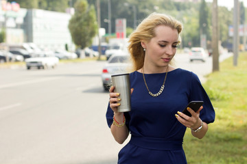 woman with cellphone is catching the taxi