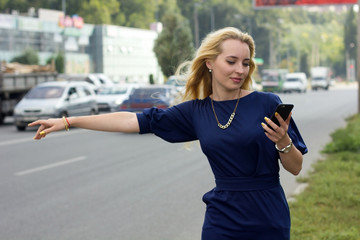 woman with cellphone is catching the taxi