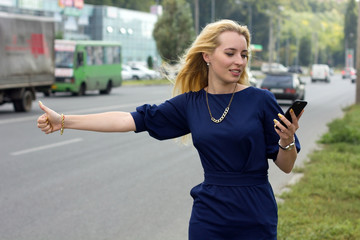 woman with cellphone is catching the taxi