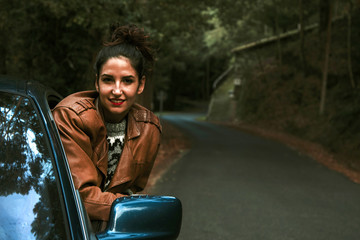 Naklejka premium enjoying girl in the car on the road