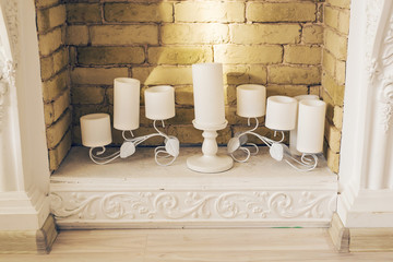White decorative fireplace with candles