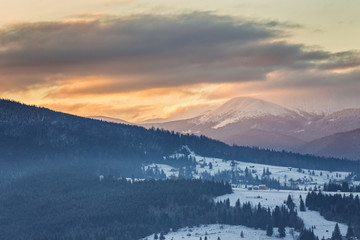 Naklejka na ściany i meble Beautiful winter landscape in the mountains. Sunrise