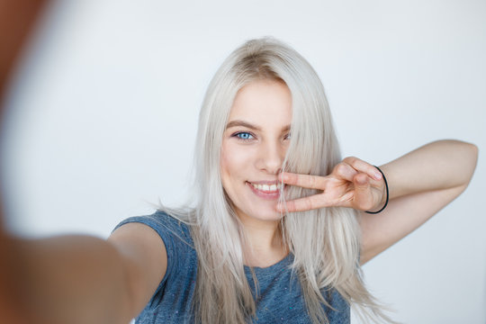 smiling young girl making selfie photo