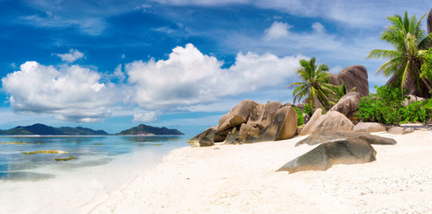 Panorama of tropical beach at Seychelles, La Digue island and Praslin island on the horizon.