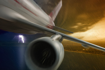 Jet in stormy sky with lightning