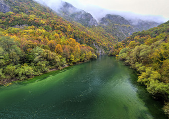 Beautiful landscape with river in the mountain and colorful autumn forest