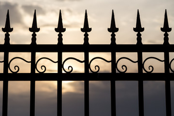 Fototapeta na wymiar metal fence at sunset