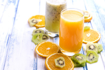 Fresh orange and kiwi juice in glass