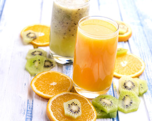 Fresh orange and kiwi juice in glass