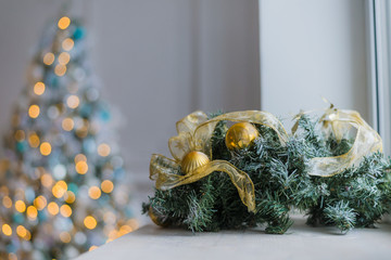 Gold and blue Christmas background of de-focused lights with decorated tree