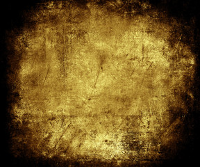 Beautiful gold abstract vintage grunge background with faded central area for your text or picture, scratched scary background with frame