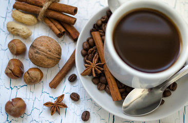 Fototapeta na wymiar Coffee Mug among spices and nuts.