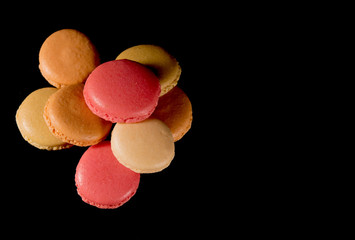 Sweet and colorful french macaroon or macaron on black background