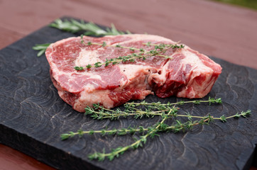 Rib eye steak on wooden board