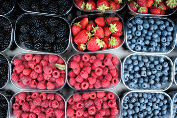 Strawberries, cherries, raspberries and blackberries in the local market.