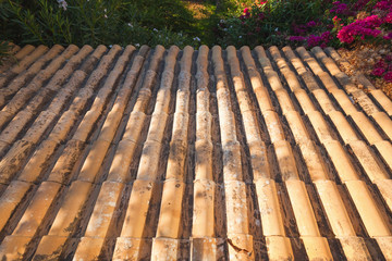 Old tiling roof slope goes down