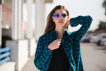 Urban fashionable girl posing outdoors in the city