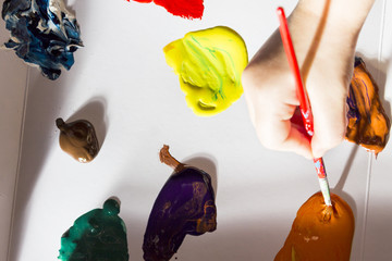 Tempera - Acrylic Colors  with Human Hand with Brush. Mixing Colors Detail.