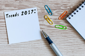 Trends 2017 written on notice at office workplace background with empty space for text. Business...