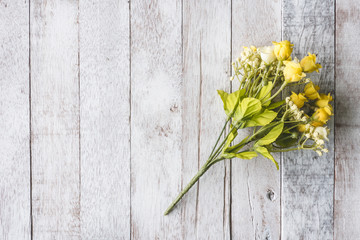Top view of  Yellow flowers on wooden table background.