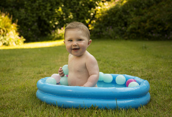 baby girl in a paddling pool
