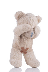 Toy bear with adhesive bandages on his private parts 3/4 view