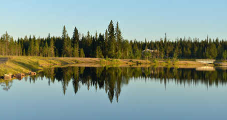 Reflection. Coastline of northern lake. Lapland, Finland