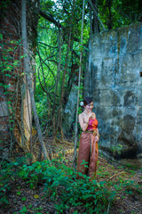 Naklejka na ściany i meble Asian woman wearing dress traditional Thai costume ,beautiful women thai in the past.