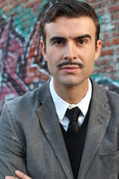 Flamboyant retro man with mustache over urban alley way city with graffiti background 