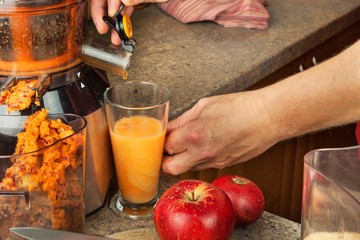 Domestic production of fresh apple juice. Fruit processing. Production of fruit drinks. Healthy lifestyle.
