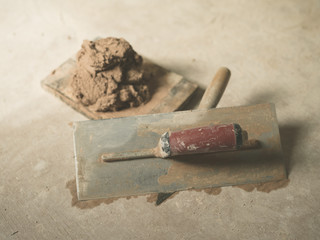 Trowel and plaster on floor