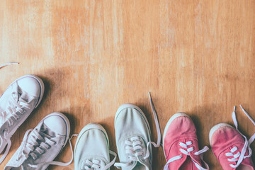 Top view of Colorful sneakers on the wooden table background.