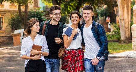 A beautiful day to be on campus.Shot of college students hanging out on campus.