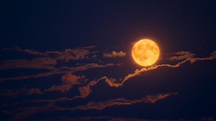 Fototapeta premium Red moon upon a cloudy sky