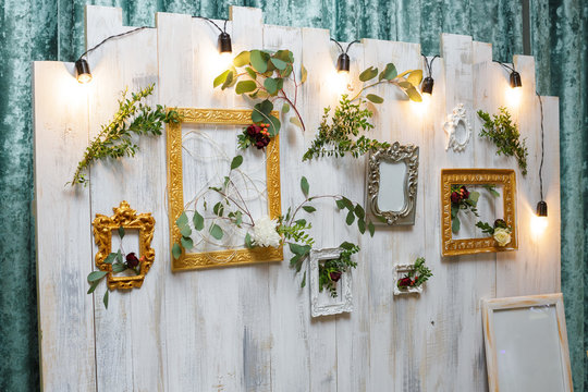 vintage frames and flowers hanging on the wall. 