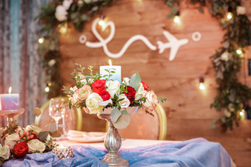 candle and a bouquet of roses