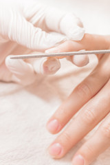 Fototapeta premium woman in a beauty salon receiving manicure
