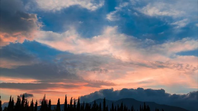  Clouds over mountains at sunset, time lapse / Movement of multicolored clouds over mountains at sunset, play of paints on sunset sky, time lapse, 4k 