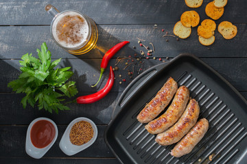 Homemade Grilled Sausages, Snacks and Beer on the wooden backgro