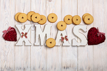 Merry Christmas! Cookies with jam hearts and wooden letters XMAS