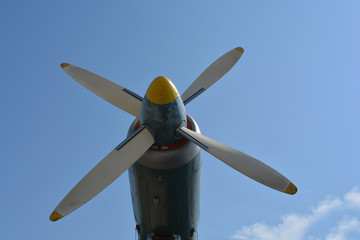 Naklejka na ściany i meble Airplane propeller engine against blue sky closeup