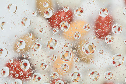 Colorful candies reflected in the water drops.