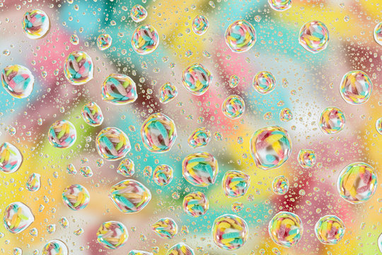 Colorful candies reflected in the water drops.